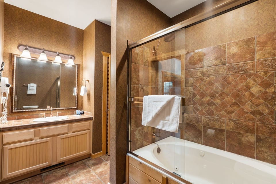 Bathroom One- Attached to Bedroom One, Shared Access to the Living Area- Jetted Tub/Shower Combo
