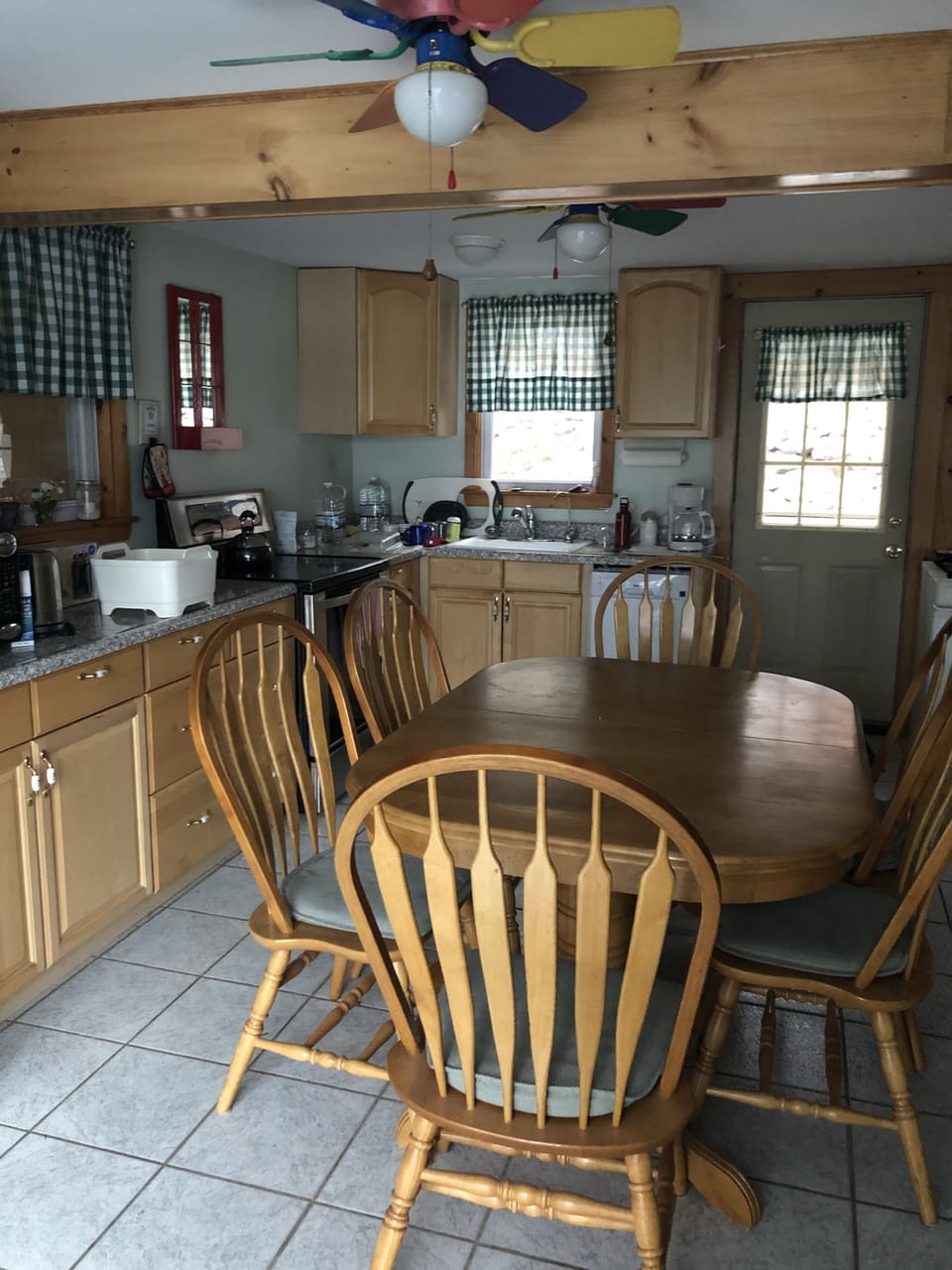 Kitchen area with large dining table and full size stove