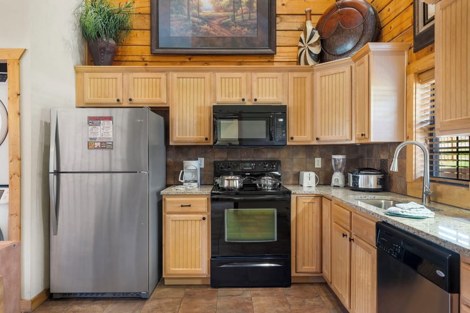 Rustic kitchen with stainless appliances and granite countertops—fully equipped for your stay.