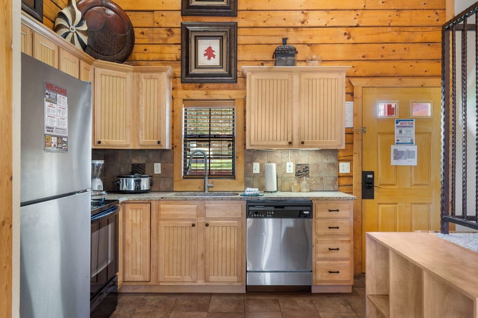 Rustic kitchen with stainless appliances and granite countertops—fully equipped for your stay.