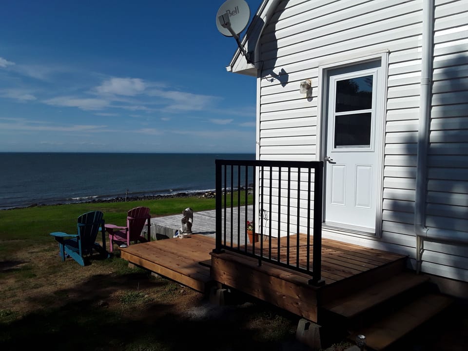 Side door leading out to oceanfront deck and lawn