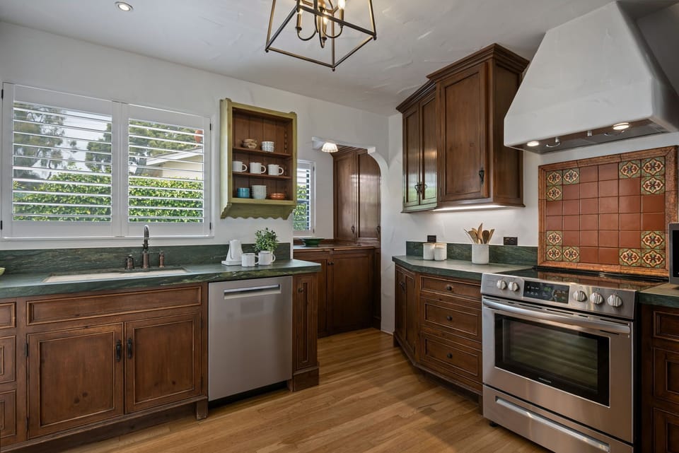 Stainless steel appliances are accented with Spanish tiles