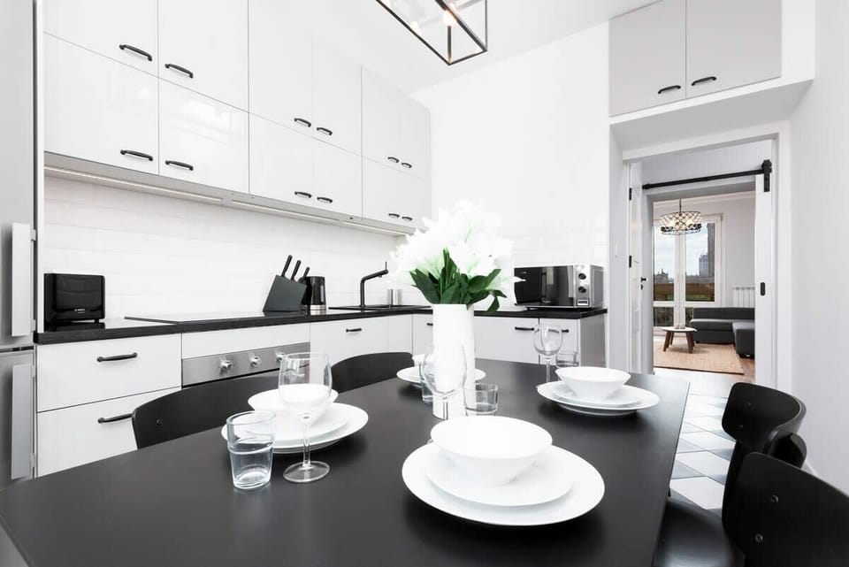A close-up of a dining table with tableware in white. 