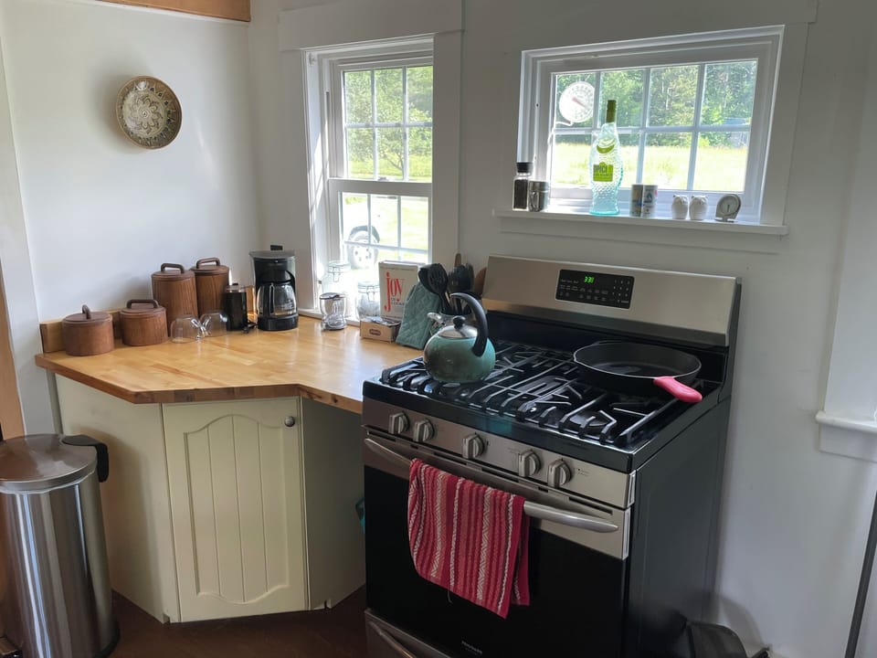 Kitchen: gas stove, butcher block counters, and coffee and tea prep