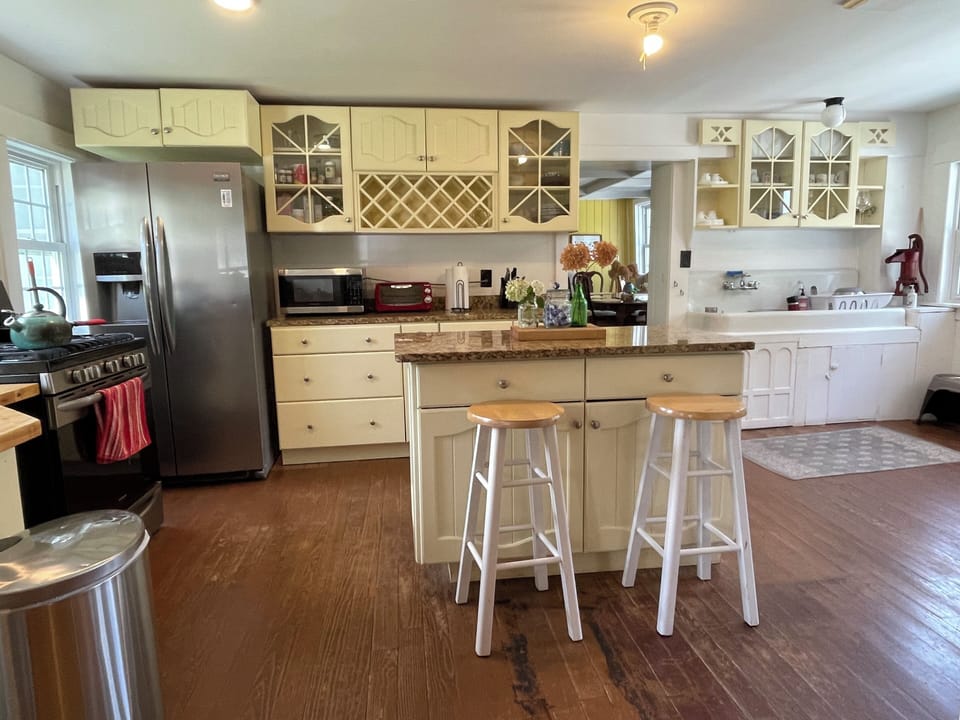 Kitchen: 6 burner gas stove, granite counter tops, old sink and pitcher pump