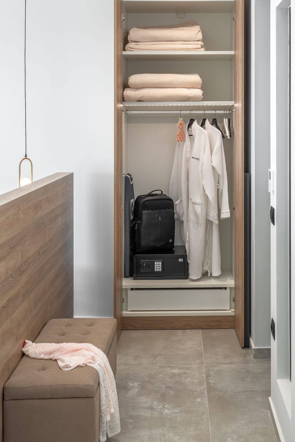 An open closet and safe are available in the bedroom.