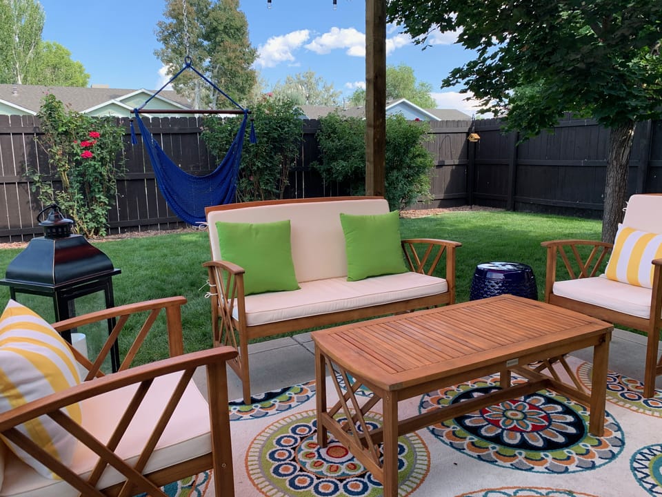 Covered patio with seating for 6 and hammock