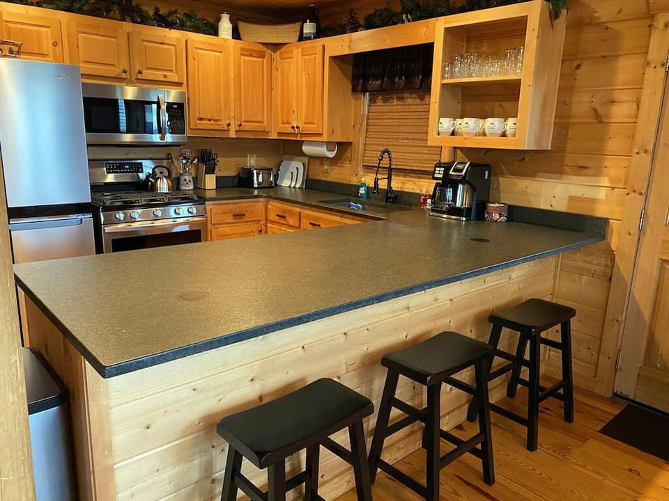 Fully-stocked kitchen with granite countertops and stainless steel appliances.