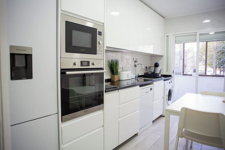 Kitchen: Sleek, modern design with high-end appliances for culinary adventures!