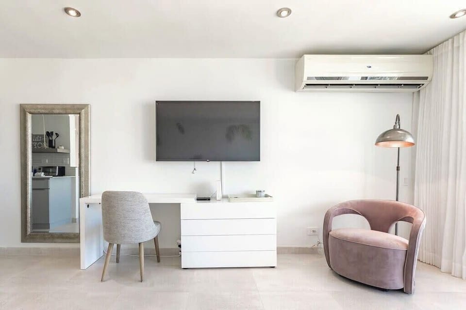 Flat screen TV, armchair and drawer/desk