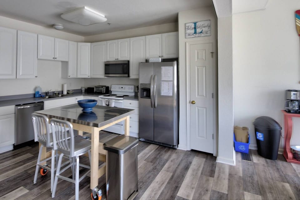 The kitchen is well stocked and has extra seating at the island.
