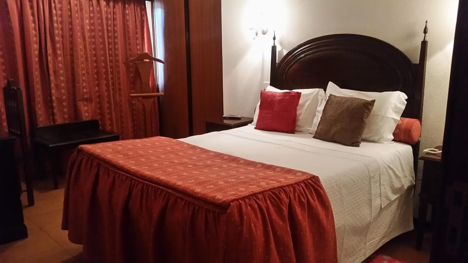 Hypo-allergenic bedding, desk, laptop workspace, blackout drapes