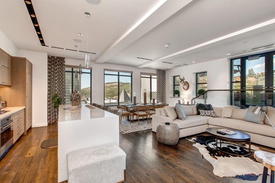 Great Room - Living Room, Kitchen and Dining Area with Hardwood Floors Throughout