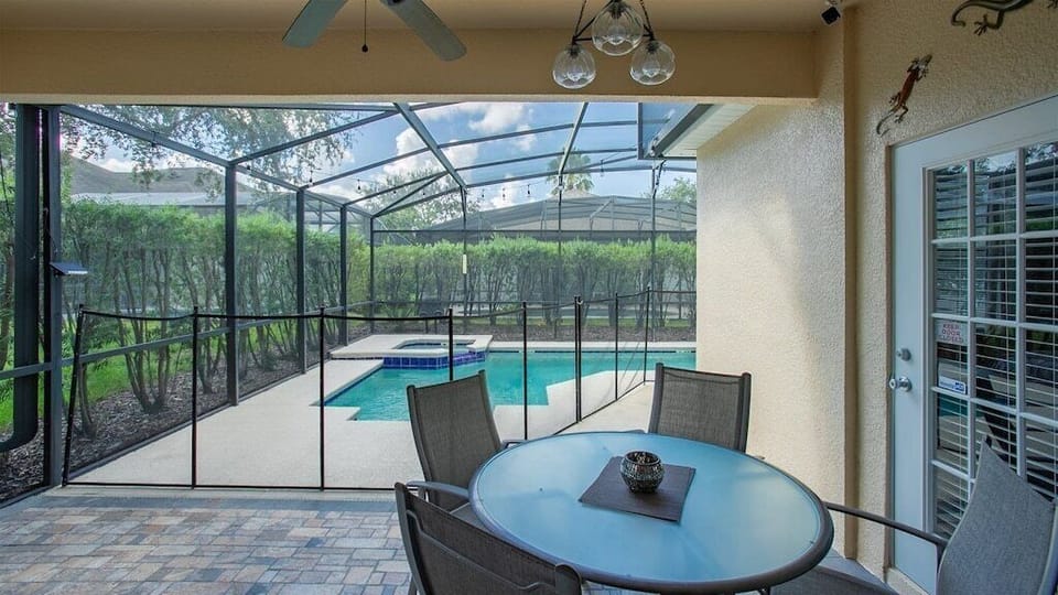 Enjoy poolside dining in the screened patio with stunning views and fresh air.