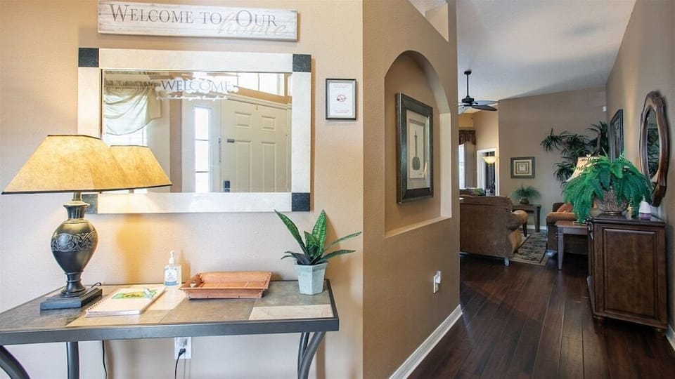 Welcoming entryway with stylish decor and a convenient workstation for your needs.
