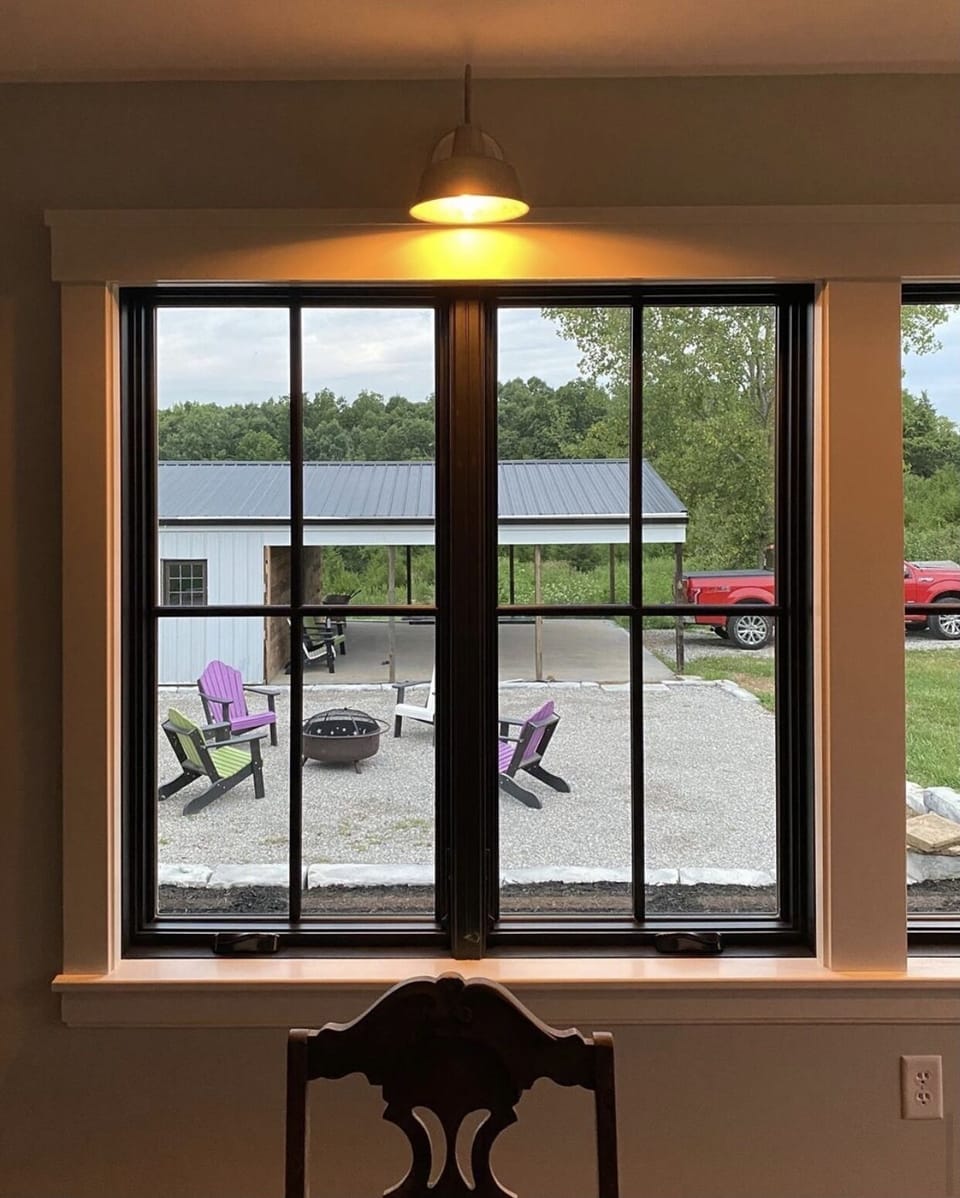 Looking out the sunroom to the fire pit and pavilion 