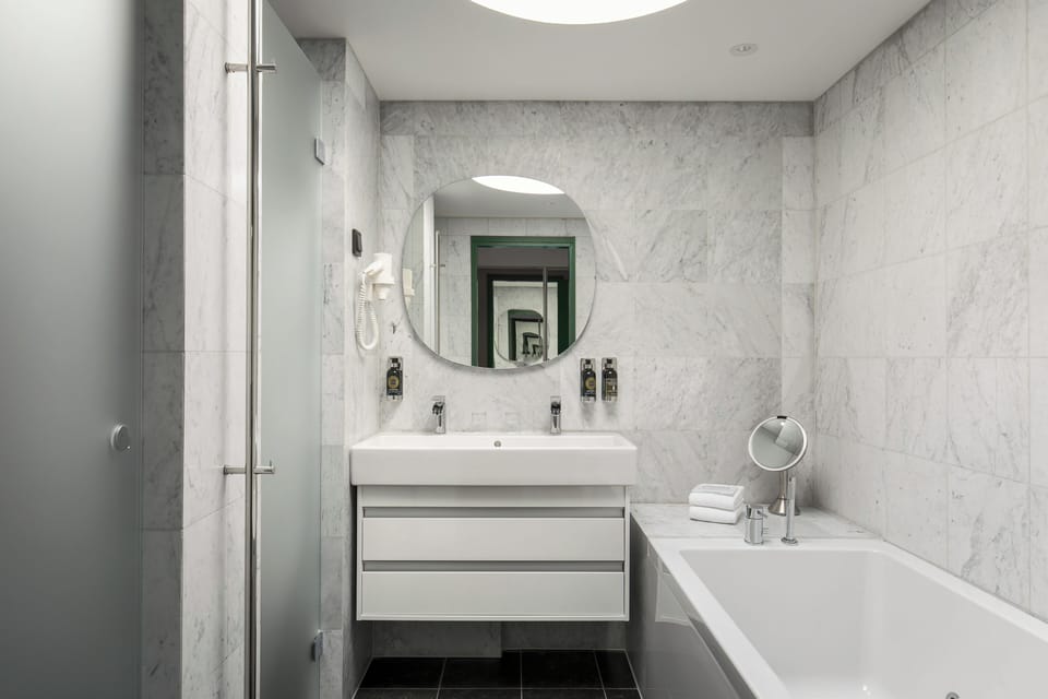 Junior Suite | Bathroom | Designer toiletries, hair dryer, slippers, towels