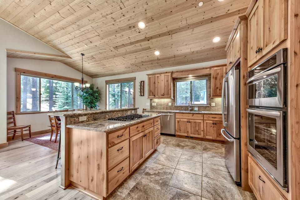 Your rustic mountain kitchen awaits with gleaming granite counters, premium appliances, and warm wood details perfect for creating memorable meals.
