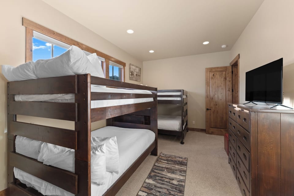 Your group will love this cozy bunk room with twin beds, a flat-screen TV, and mountain views through the window.