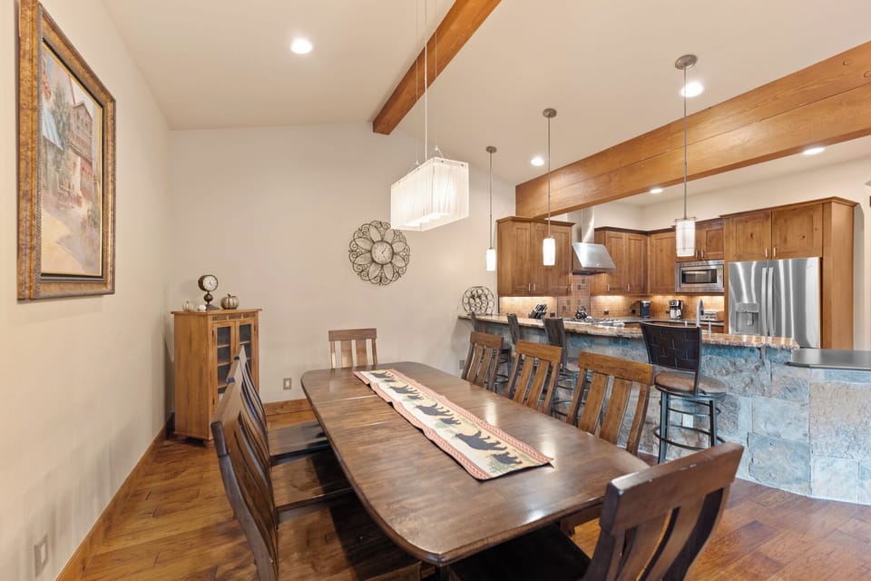 Gather around your spacious dining table with rich wood finishes and stone accents creating the perfect atmosphere for memorable meals together.
