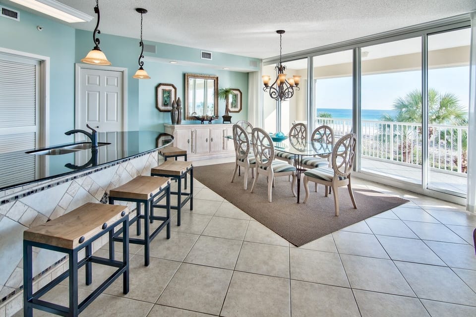 Dining room table has seating for 6 plus 4 chairs at the counter.