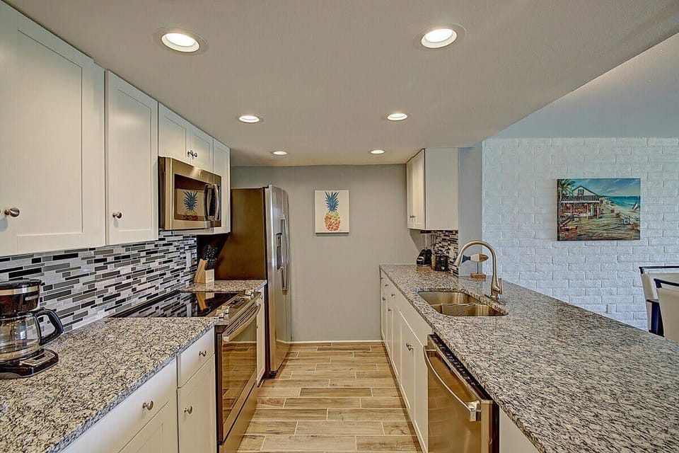 Large kitchen with lots of granite countertop space