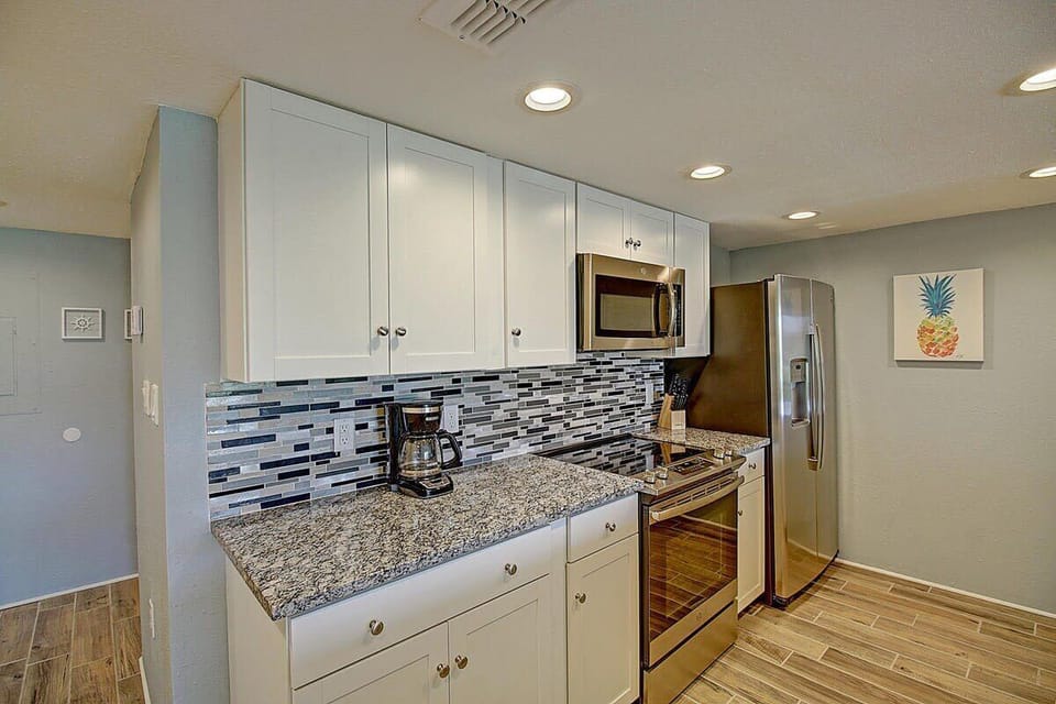 Large kitchen with lots of granite countertop space