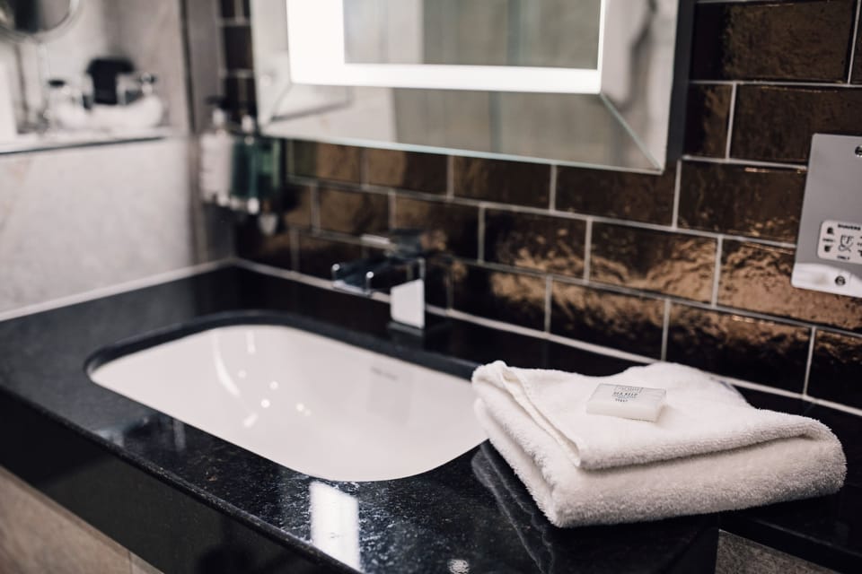 Combined shower/tub, hair dryer, towels, soap