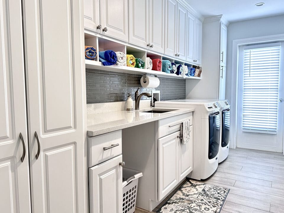 Laundry room with plenty of storage and broom closet.  New (2023) front load washer and dryer.