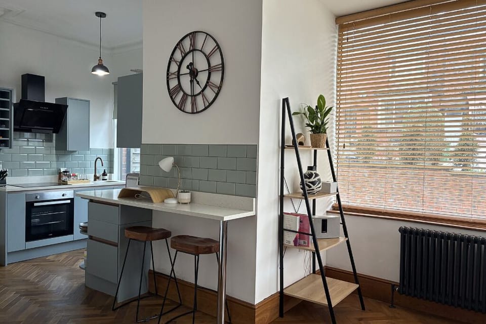 Open-plan living space with comfortable seating and breakfast bar dining area