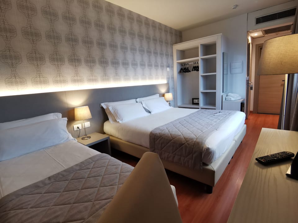 Superior Triple Room | Minibar, in-room safe, desk, blackout drapes