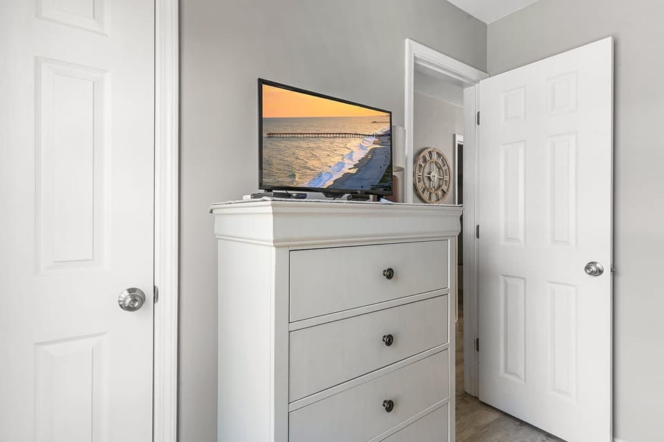 Bright and airy bedroom corner with modern storage and decor