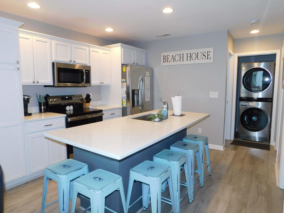 Bright modern kitchen with spacious island and laundry area