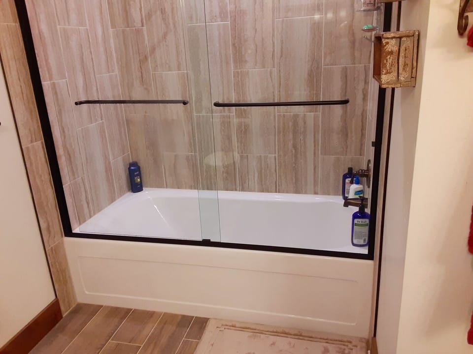 Master first floor  bathroom with  large tub and shower combination.