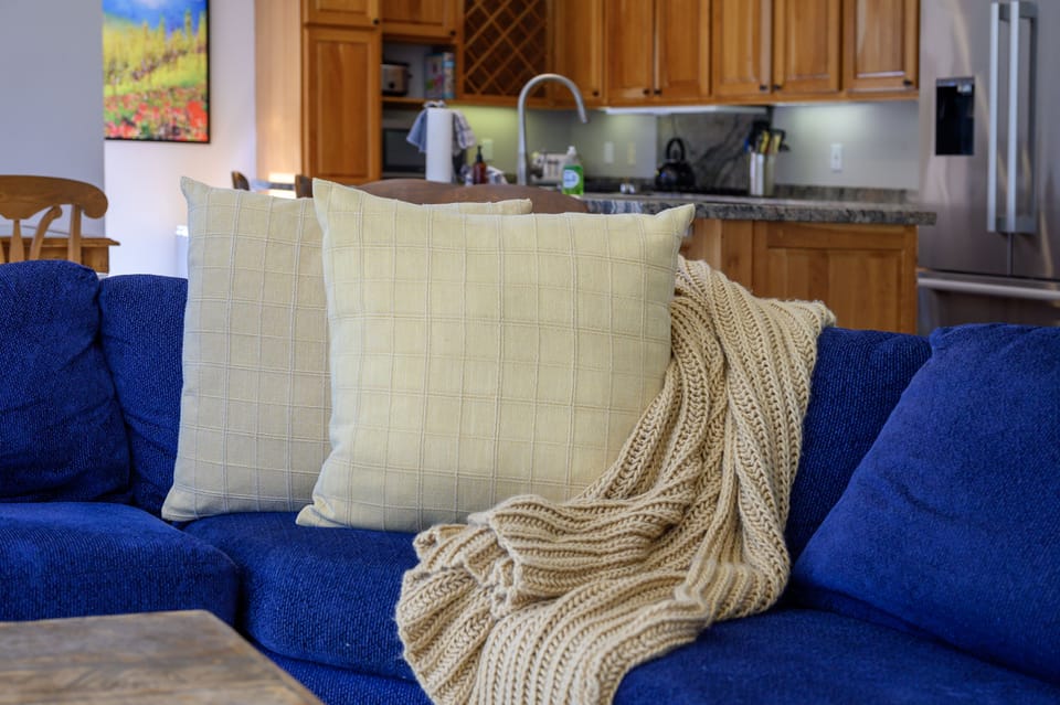 Relax in style on the blue sectional and soak up the view out the large windows