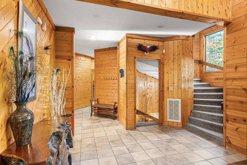 Foyer on the main level with spiral staircase up and down.