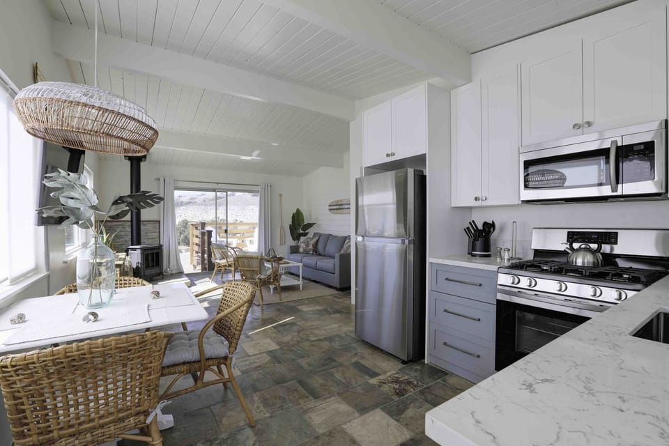 Remodeled kitchen with chef grade appliances. Full size refrigerator, stove/oven, microwave. Kitchen is fully stocked with cookware, dinnerware and serving dishes. The dining table with accommodate 4.