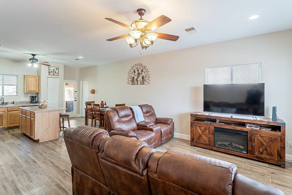 The living room has a large smart TV, and a comfortable love seat and couch to relax on. Watch a movie or sit and visit with friends or family.