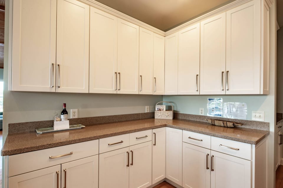 The kitchen features new white cabinets and granite countertops.