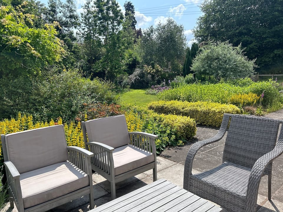 Soft seating area in the beautiful garden on south terrace  at The Cider Mill
