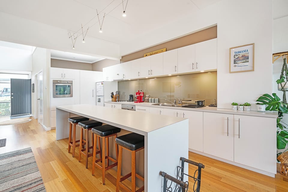 Cook with ease in the bright, modern kitchen, complete with sleek cabinetry, quality appliances, and a spacious island for relaxed breakfasts or evening gatherings.