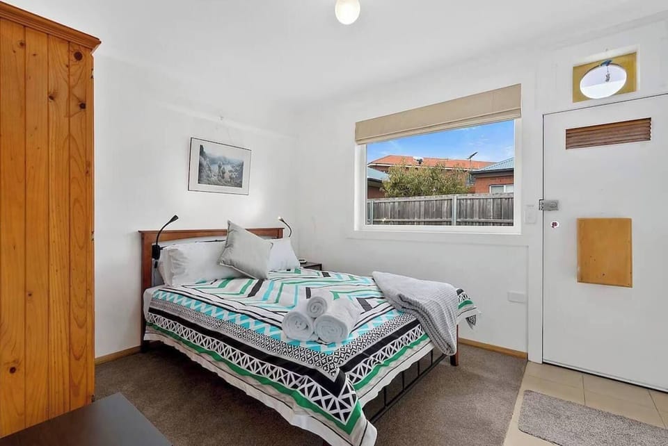 The second bedroom also offers a queen size bed along with window blinds and storage space for your belongings.