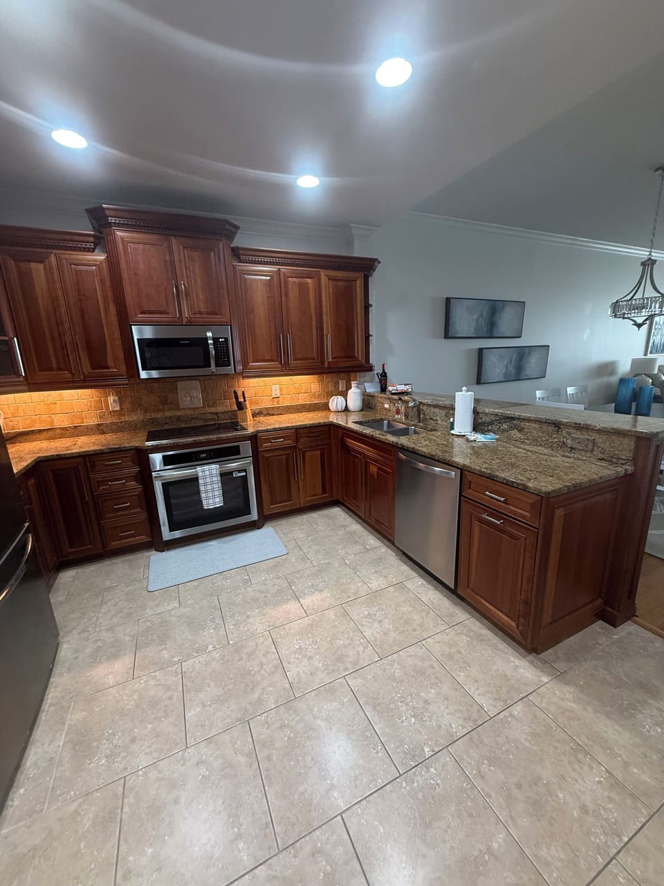 Kitchen with brand new appliances and all basic utensils/tableware.