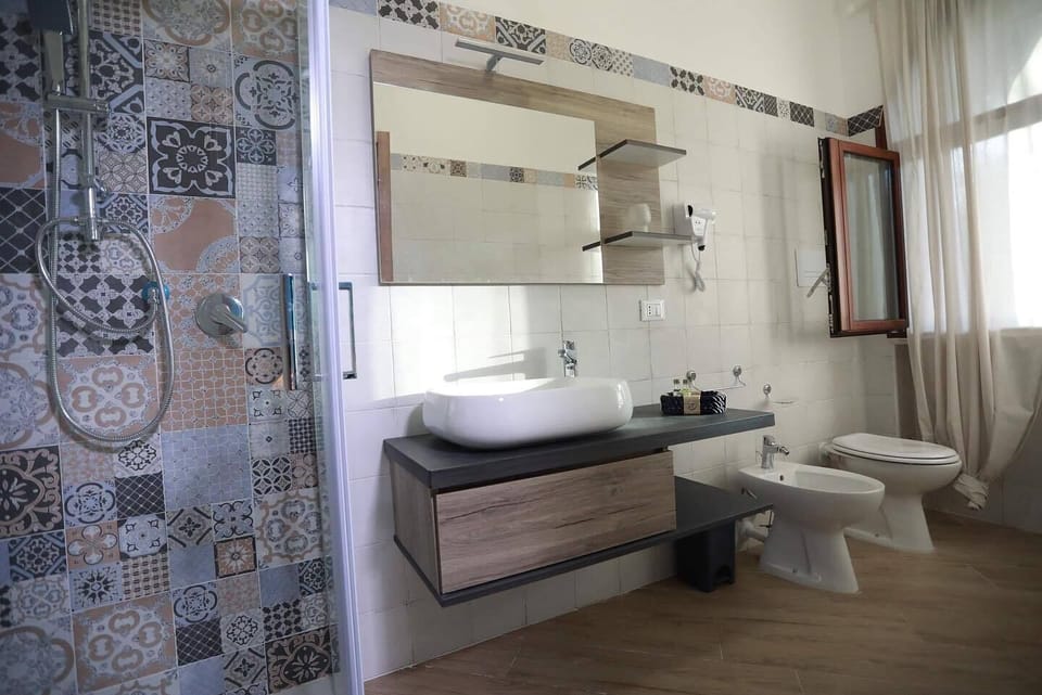 Deluxe Double Room, Garden View (Circe) | Bathroom | Shower, hair dryer, bidet, towels