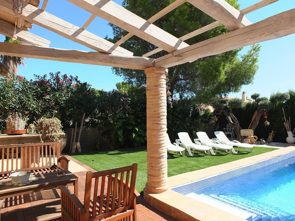 Chill out area next to the beautiful swimming pool and surrounded by the private garden