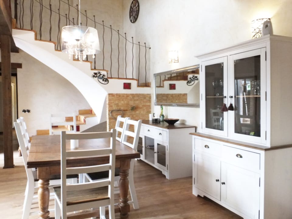 Bright living/dinning room with beautiful staircase upstairs
