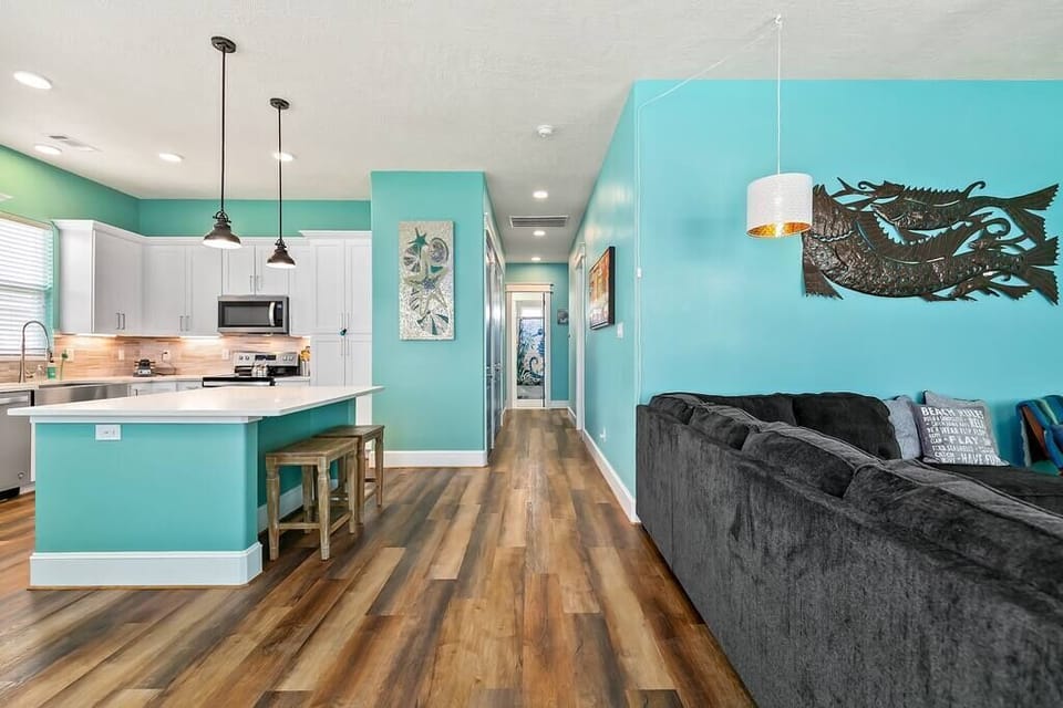 Entryway showing kitchen and island to left and Living room to right