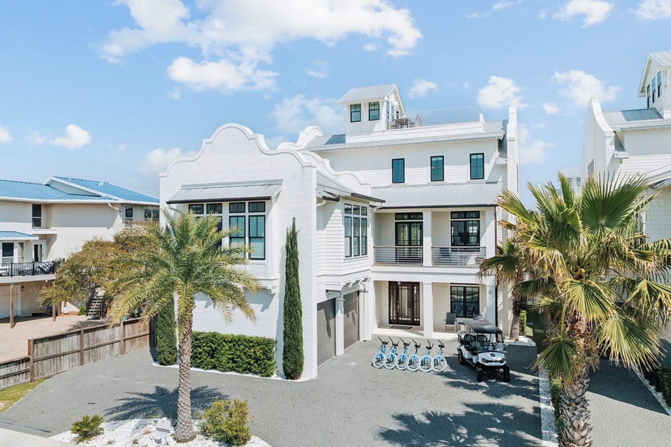 Modern coastal architecture with palm trees and tropical landscaping creates an inviting beachside retreat.