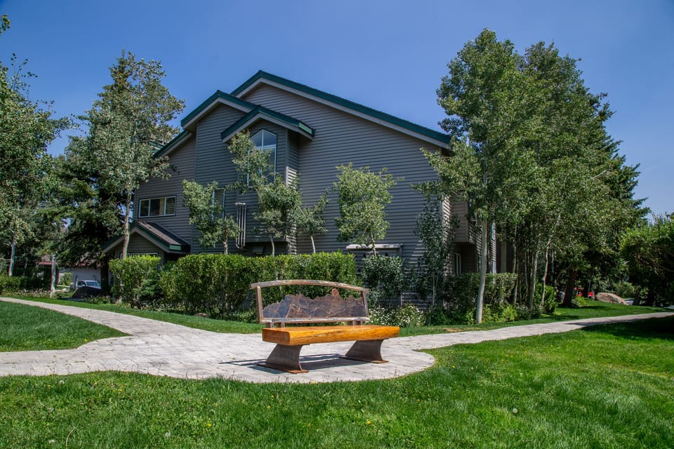 Peaceful setting with park benches and pathways meandering by the creek.