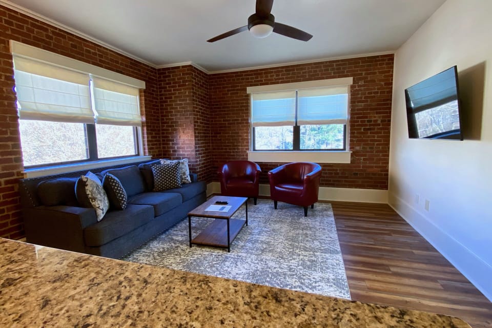 Spacious Living Room Features A Queen Size Sofa Bed